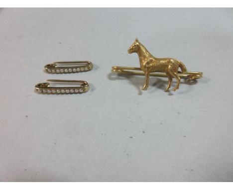 A pair of seed pearl tie pins, cased by Tiffany, New York together with a horse pin brooch, the identical tie pins of short b