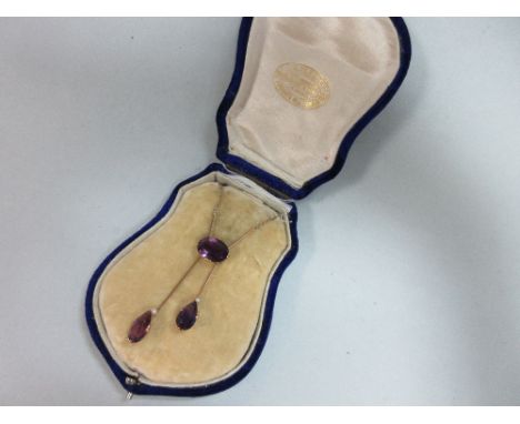 An amethyst and seed pearl negligée necklace, set to the front with two knife-edge bars holding a horizontal oval cut amethys