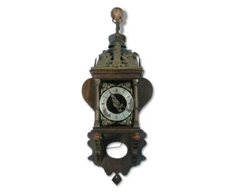 A Dutch oak lantern-type Zaanse wall clock, late 18th or 19th century, marked around the fret mounts 'Nu Elck Syn Sin', the t