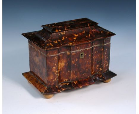 A 19th century tortoiseshell two compartment tea caddy, the veneers on the shaped rectangular body separated by silver wires,