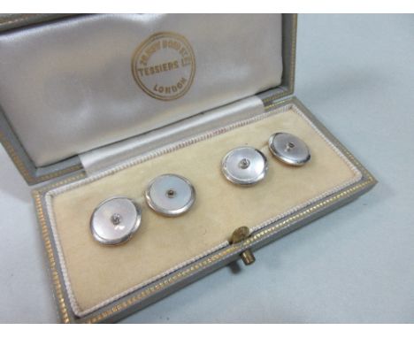 A pair double-ended diamond and mother of pearl cufflinks cased by Tessiers, each link a circular mother-of-pearl disc with a