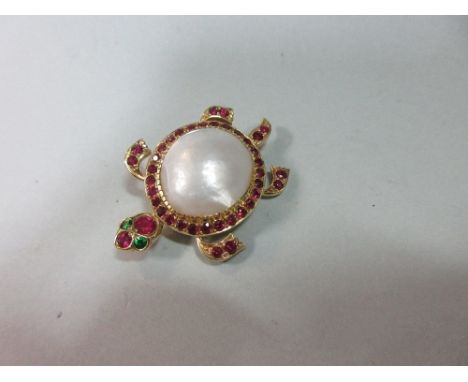 A novelty gem set turtle brooch, the body formed by a mabé pearl, the edge of the shell, flippers, head and tail delineated b