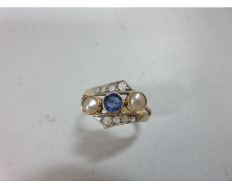 A sapphire, natural pearl and diamond ring, of crossover form, with a light blue round cut sapphire between two half pearls (