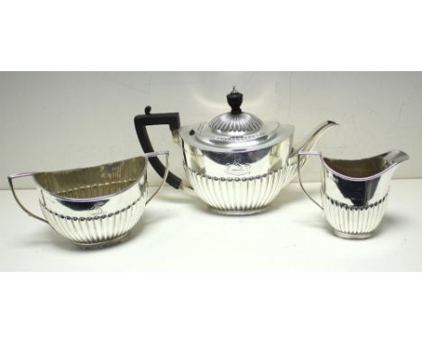 A Victorian matched three piece teaset, by Gibson & Langman, Sheffield 1883/1885/1891, comprising:- a teapot of oval shape th