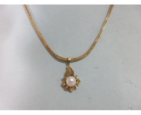 A square section barley link chain with associated pearl pendant, the 71cm long chain stamped '750' to indicate 18ct gold, wi