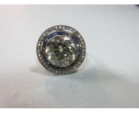 A four carat diamond in a 1920s sapphire and diamond double halo surround, the round brilliant cut diamond, estimated weight 