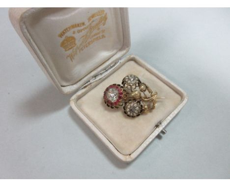An antique diamond, ruby and pearl flower spray brooch, the top flower with a large rose cut diamond centre in a border of ov