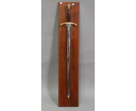 A late 20th century Wilkinson Sword presentation sword, blade length 87cm, one side of the blade with foliate decoration and 