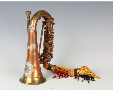 An early 20th century brass-mounted copper bugle with applied badges of the Royal Scots Regiment, personalized to '7444. Bugl