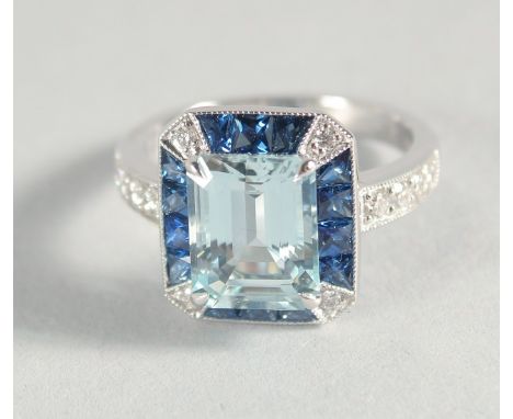 AN 18CT GOLD, AQUAMARINE, SAPPHIRE AND DIAMOND RING.