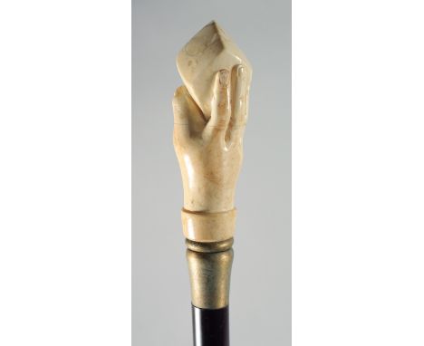 A CARVED BONE HAND AND CUBE HANDLED WALKING STICK.