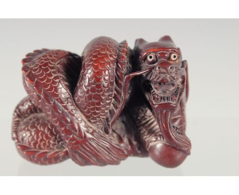 A CARVED WOOD DRAGON NETSUKE 2ins