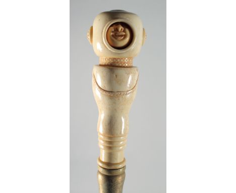 A CARVED BONE MOVING HEAD HANDLED WALKING STICK.