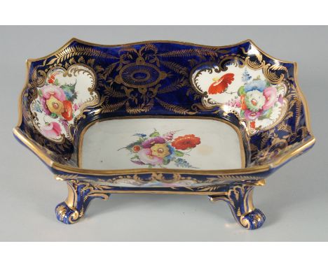 A GOOD SPODE RECTANGULAR FRUIT DISH rich blue ground painted with panels of flowers supported on four curving legs. 10ins lon