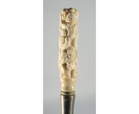 A CARVED BONE EROTIC HANDLED WALKING STICK.