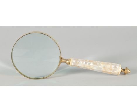 A MAGNIFYING GLASS with a mother of pearl handle.