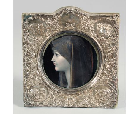 A GOOD 19TH CENTURY LIMOGES ENAMEL PLAQUE "MADONNA". 4ins x 2.75ins framed in a silver frame.