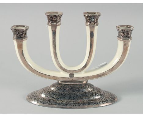 A ROSENTHAL ART DECO FOUR LIGHT PORCELAIN CANDLESTICK on a silvered base. 8.5ins high.