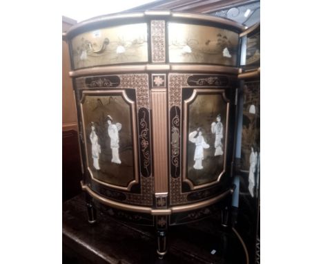 A Chinese black lacquer and gilt decorated demi-lune side cabinet with mother of pearl figures. 