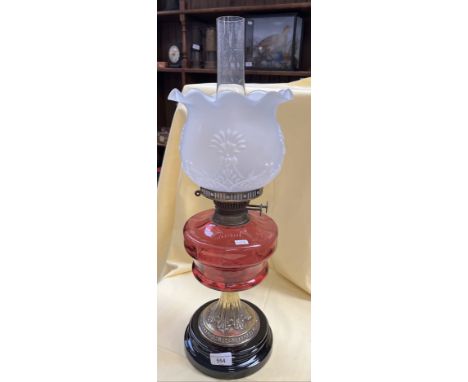 A ruby glass oil lampCrack, possible repair to collar under basin, chip to base, no other damages. 
