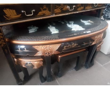 A Chinese black lacquer and gilt decorated coffee table / nest of tables decorated with mother of pearl relief figures. 