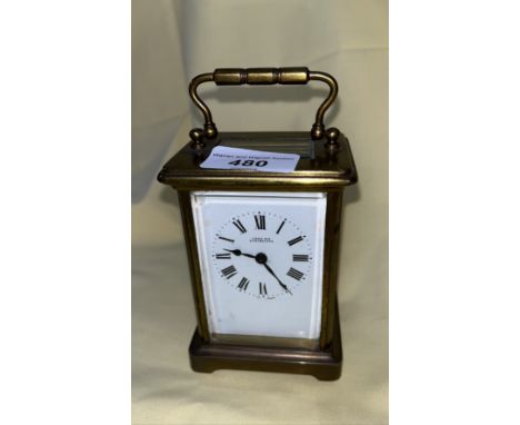 A brass carriage clock by John Nix, Eastbourne. 