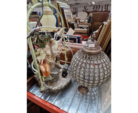 A light fitting and a figural water feature. 