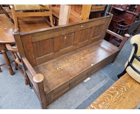 An oak monk's bench. Dimensions- height 102cm, length 187cm and depth 55cm (overall). Height to seat 45cm, height to arms 70c