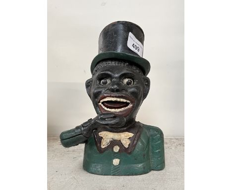 A cast metal money bank.Note:- These items are listed on the basis they are illustrative of a bygone culture in which there w