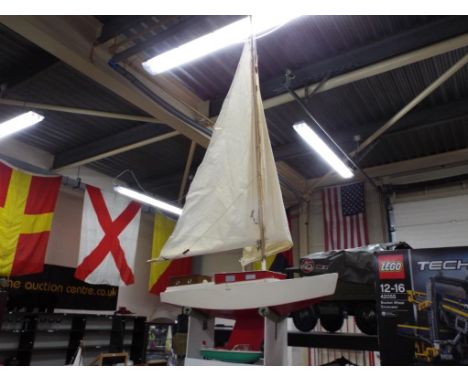 R/C Boat - Wooden scratch built yacht with battery operated rudder on stand, along with unboxed tinplate clockwork boat by Su