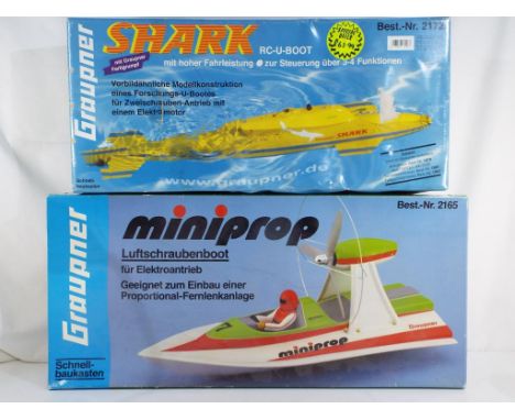 R/C Boats - Two radio controlled boats in original boxes by Graupner comprising a Shark Submarine which hasn't been assembled