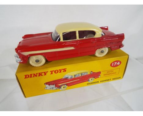 Dinky - Hudson Hornet Sedan # 174 comprising red lower body, cream roof and side flashes, ribbed hubs, white tyres in origina