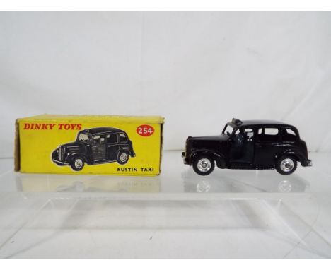 Dinky Toys - A Dinky Toys # 254 Austin Taxi, black body, spun hubs, grey interior with driver, contained in correct all card 