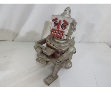 A cast iron novelty mechanical money bank in the form of a robot. Estimate £15 - £25