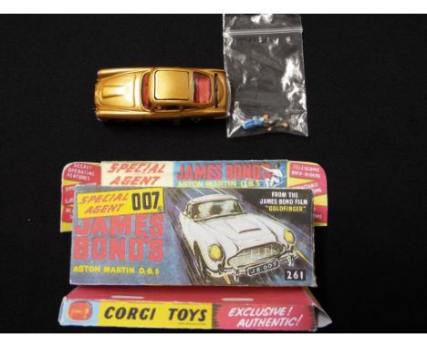 Corgi - an original diecast James Bond D.B.5 #261 with professional re-paint in repro box, model in mint condition. This lot 