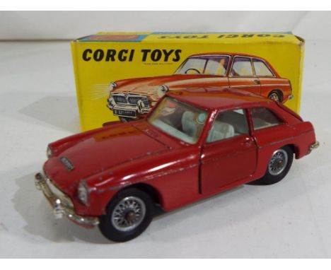 Corgi Toys - a diecast model M.G.B. G.T. red body, light blue interior, spoked wheel hubs, vg+ in exc to nm original picture 