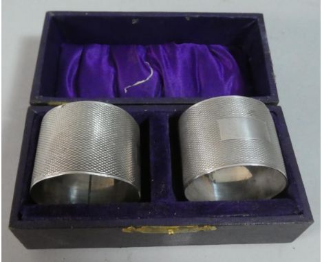 A Pair of Cased Silver Engine Turned Napkin Rings 