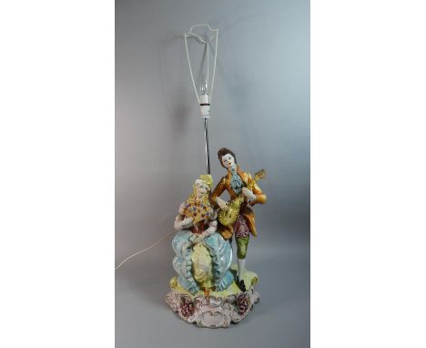 A Large Naples Ceramic Figural Table Lamp, Musician and Lady with Fan, Total height 96cm 