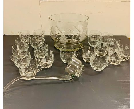 An engraved glass punch bowl with ladle and nineteen cups in total, ten in one style and nine in another.