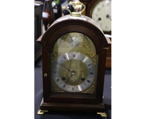 Mahogany cased chiming mantel clock raised on brass bracket feet, H: 26cm. Not available for in house P&amp;P.