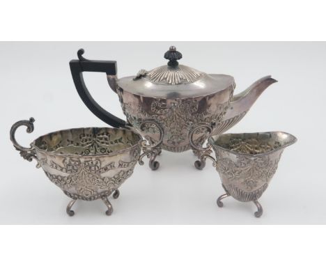 Victorian hallmarked silver heavily embossed Victorian tea service, each piece raised on scrolling supports, Birmingham assay