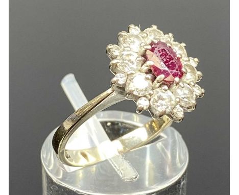 18CT WHITE GOLD RUBY & DIAMOND CLUSTER RING, central oval ruby with surround of claw set brilliant cut diamonds, size L/M, 4.