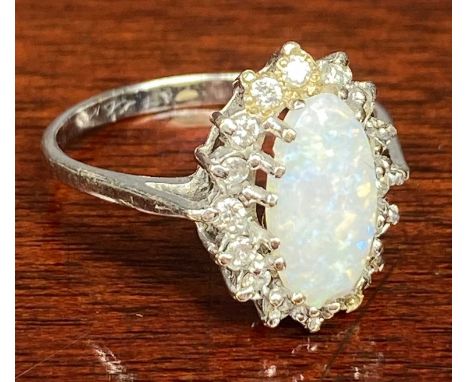 9CT WHITE GOLD OPAL RING, central oval stone surrounded by small diamonds, size N, 2.2gmsProvenance: private collection Gwyne