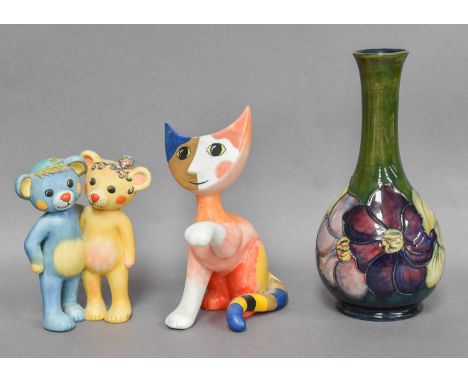 A Moorcroft Clematis Pattern Bottle Vase, together with a Goebel cat designed by R. Wachtmeister and a similar model of two b