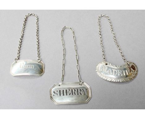 A George III Scottish Silver Decanter-Label, a George III Silver Decanter-Label and a Victorian Silver Decanter-Label, the fi