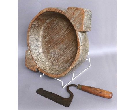An Indian Paratha Dish, or dough bowl, 20th century, wooden with twin handles; together with a kitchen tool (2)