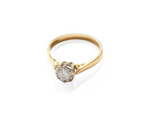 A Diamond Solitaire Ring, the round brilliant cut diamond in a white crimped setting, to a yellow tapered shoulder plain poli