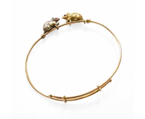 An Expanding Mouse Bangle, the mice with synthetic ruby eyes, inner measurements 6.2cm by 5.3cmUnmarked. Gross weight 11.6 gr