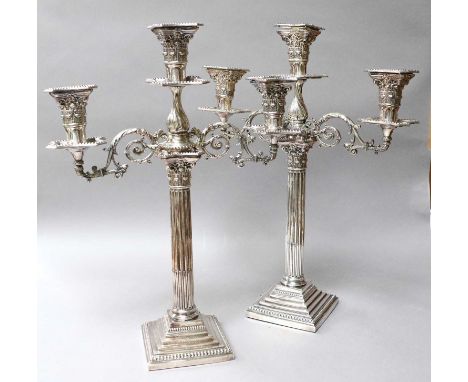 A Pair of Silver-Plated Corinthian Column Three Light Candelabra, raised on step bases, 46cm high (2) The candelabra are appa