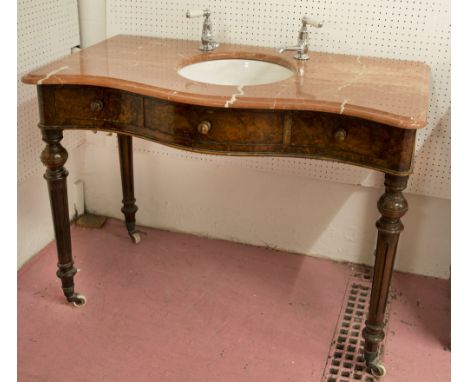 SERPENTINE WASHSTAND, Victorian burr walnut with later marble top, ceramic basin and fitted plated taps above two drawers, 89